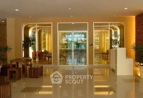 Elegant building entrance with glass doors and stylish interior design