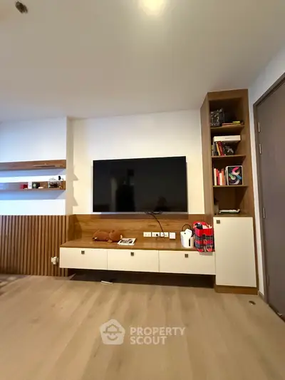 Modern living room with sleek TV unit and stylish wooden shelves