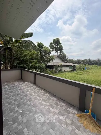 Spacious balcony with scenic garden view in a serene residential area.