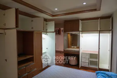 Spacious bedroom with built-in wardrobes and cozy lighting