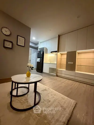Modern kitchen with sleek cabinetry and stylish decor in a cozy apartment setting.