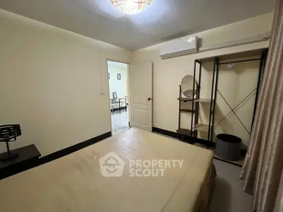 Cozy bedroom with minimalist decor and air conditioning in a modern apartment.