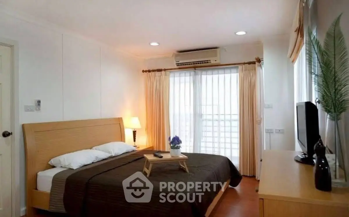 Spacious bedroom with modern decor and natural light