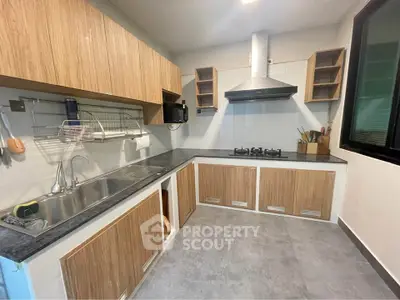 Modern kitchen with sleek cabinetry and gas stove, perfect for culinary enthusiasts.