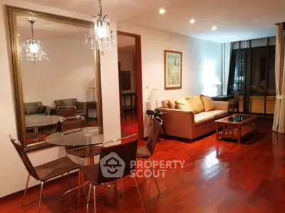 Spacious living room with elegant decor and hardwood floors in modern apartment.