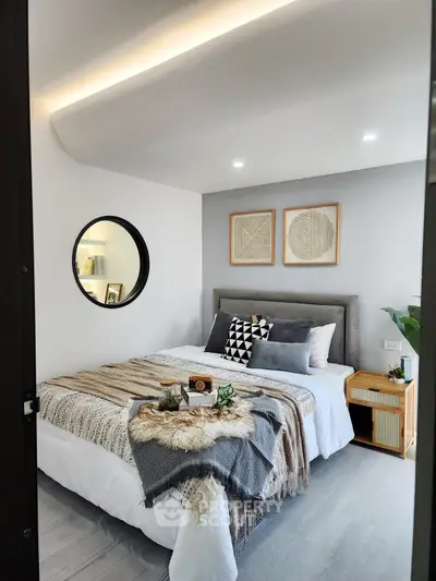 Stylish bedroom with modern decor and cozy ambiance, featuring elegant bedding and unique wall art.