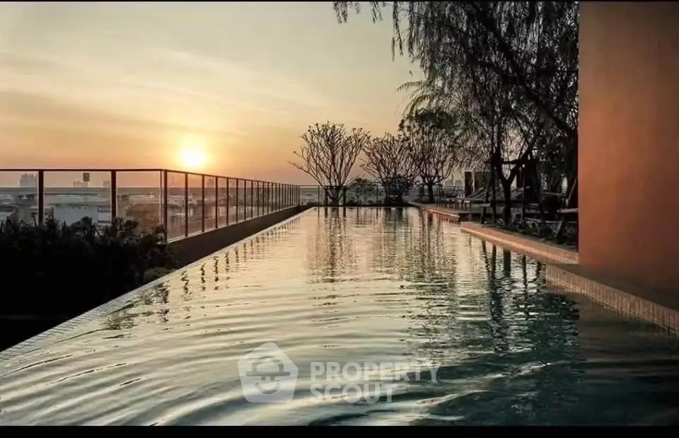 Luxurious rooftop infinity pool with stunning sunset view, perfect for relaxation and leisure.