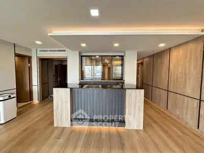 Modern open-plan living area with stylish wooden flooring and sleek design
