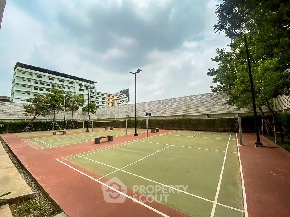 Spacious outdoor tennis court in modern residential complex