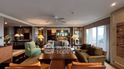 Spacious and elegant living room with luxurious furnishings and ample natural light.