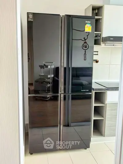 Modern kitchen with sleek black refrigerator and built-in oven