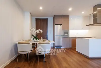 Modern kitchen and dining area with sleek design and wooden flooring