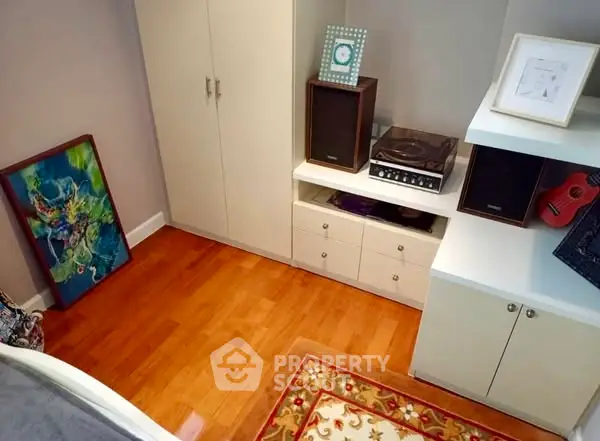 Charming study room with wooden flooring and stylish decor elements.