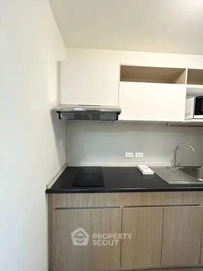 Modern kitchen with sleek cabinetry and built-in appliances in a stylish apartment.