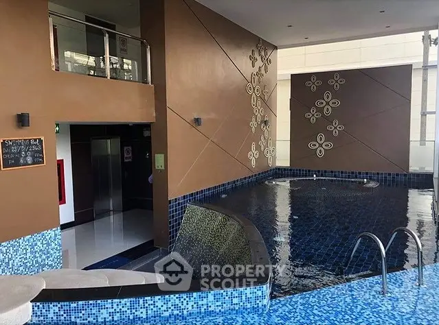Luxurious indoor swimming pool with modern design and elegant tile work.