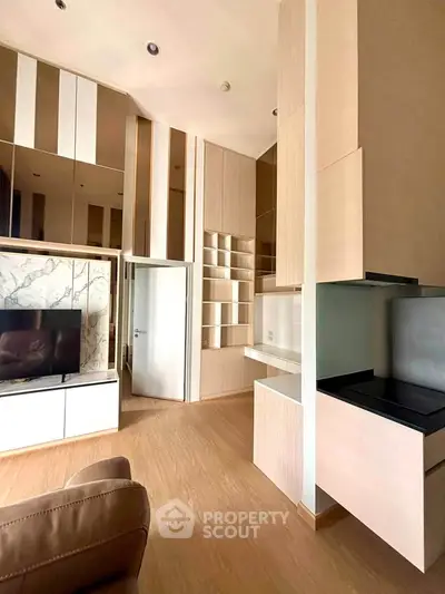 Modern living room with sleek built-in storage and stylish TV unit in a contemporary apartment.
