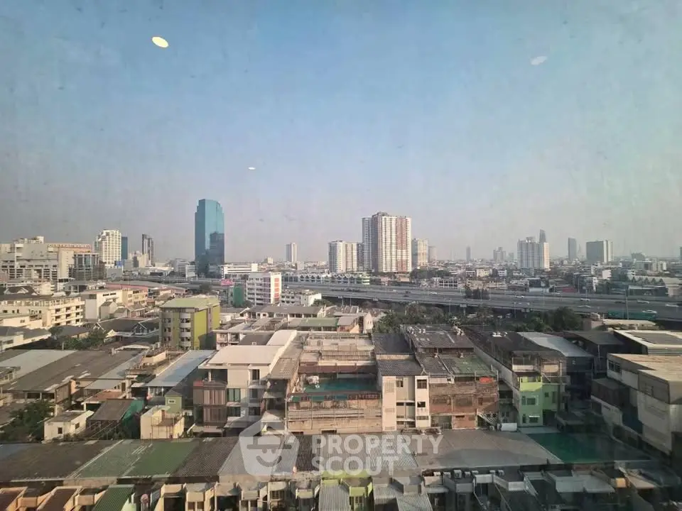 Stunning cityscape view from high-rise building showcasing urban skyline and architectural diversity.