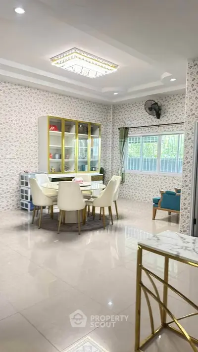 Elegant dining area with modern furniture and stylish decor in a spacious open layout.