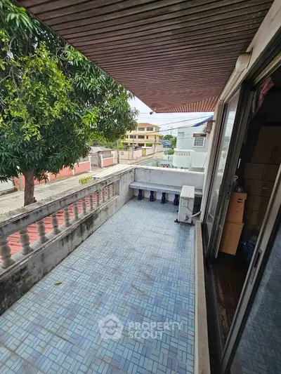 Spacious balcony with tiled flooring and street view, perfect for relaxation and outdoor enjoyment.