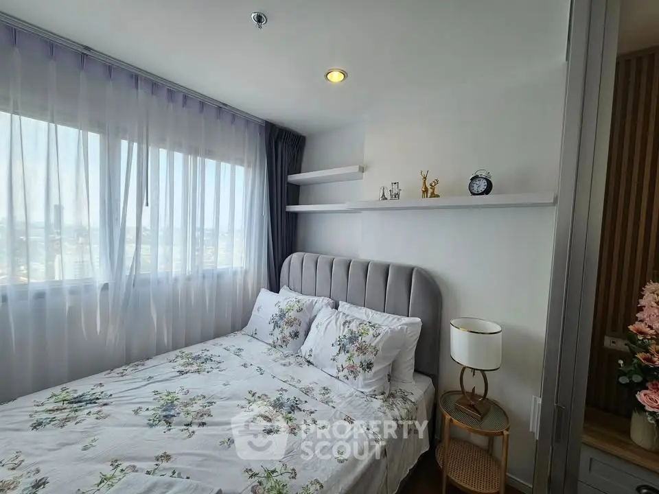 Charming bedroom with floral bedding and natural light in modern apartment