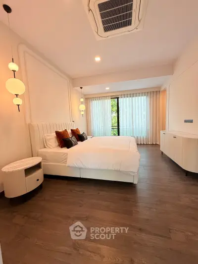 Luxurious bedroom with elegant decor and large window view