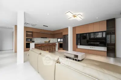 Spacious modern living room with open kitchen and sleek design