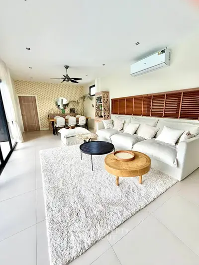 Spacious modern living room with elegant decor and ample natural light, perfect for relaxation and entertainment.