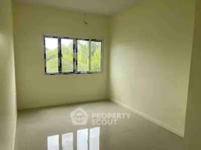 Spacious empty room with large window and glossy tiled floor, perfect for customization.