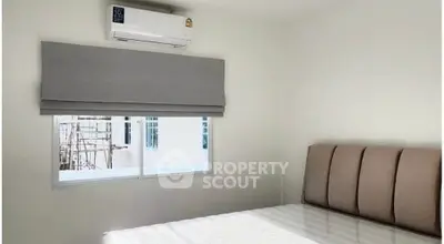 Bright bedroom with air conditioning and modern decor, perfect for comfort and relaxation.