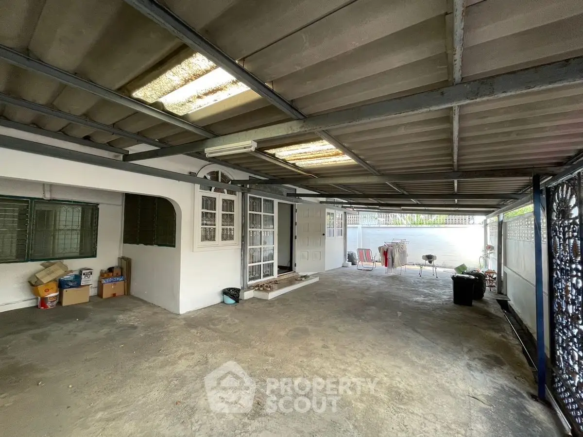 Spacious covered parking area with storage potential in residential property