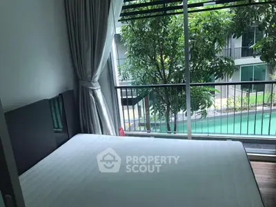 Modern bedroom with pool view and large window for natural light