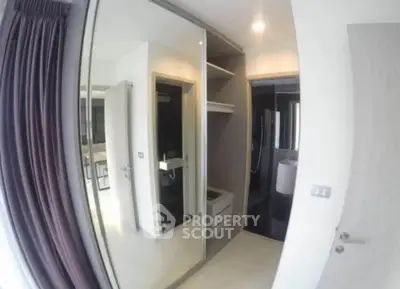 Modern bedroom with mirrored wardrobe and ensuite bathroom