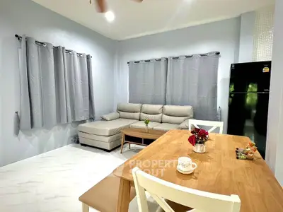 Cozy living room with modern furniture and dining area, perfect for relaxation and entertaining.