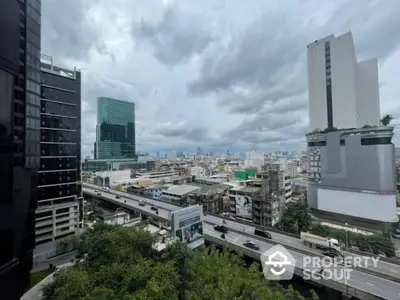 Stunning cityscape view from high-rise building with modern architecture and lush greenery.