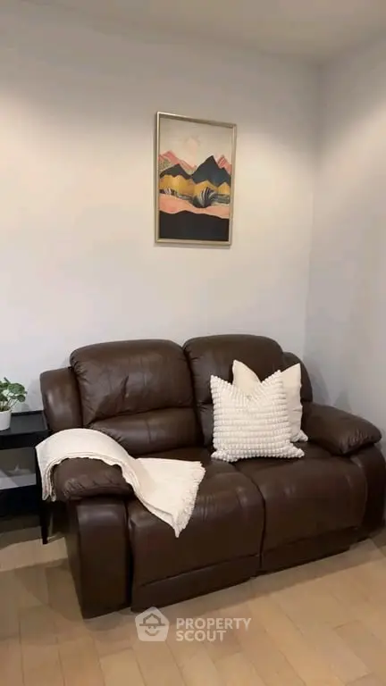 Cozy living room with brown leather sofa and stylish decor