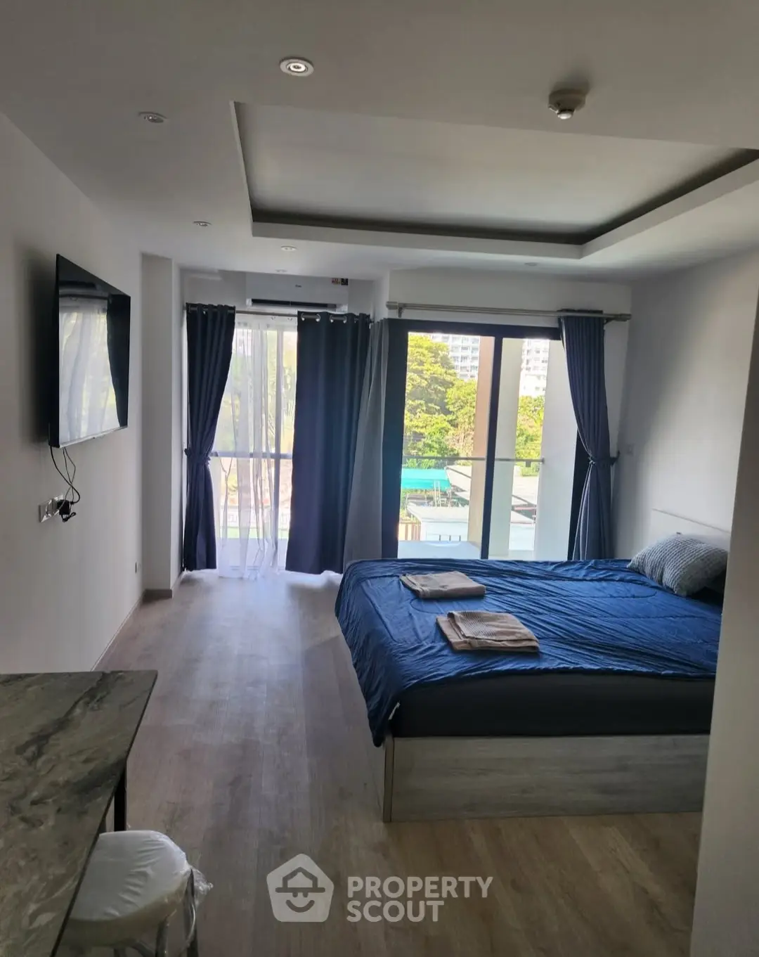 Modern bedroom with balcony view and stylish decor in a contemporary apartment.