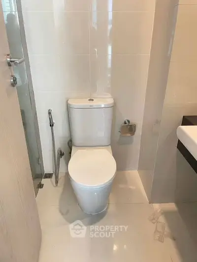 Modern bathroom with sleek toilet and glass shower enclosure