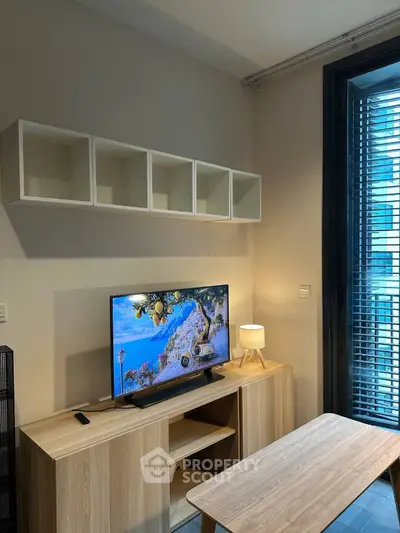 Modern living room with stylish TV setup and natural light