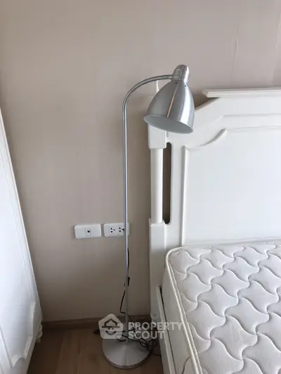 Cozy bedroom corner with elegant floor lamp and comfortable mattress