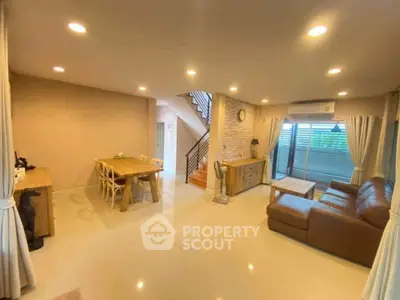 Spacious living room with modern decor and large windows for natural light