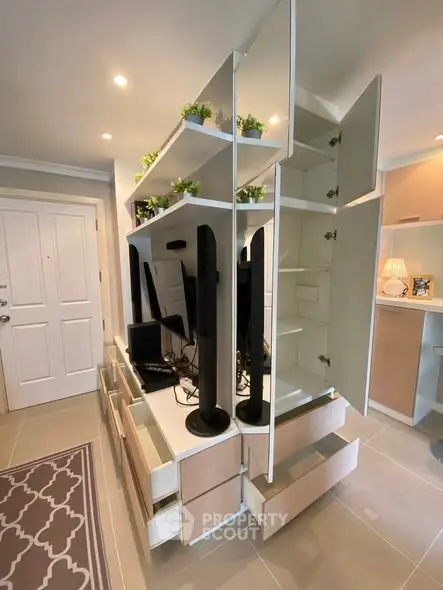 Modern living room with stylish shelving and open cabinets, showcasing contemporary interior design.