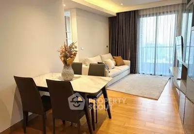 Modern living room with elegant dining area and large window view.