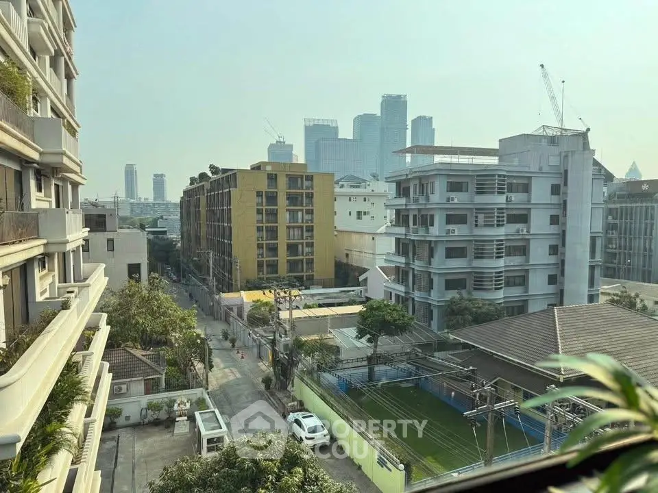 Stunning urban view from a high-rise building showcasing city skyline and modern architecture.