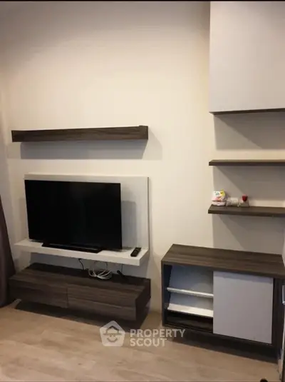 Modern living room with sleek TV stand and wall-mounted shelves