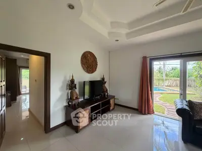 Spacious living room with pool view and elegant decor in modern home