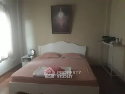 Cozy bedroom with soft lighting and simple decor, perfect for relaxation.