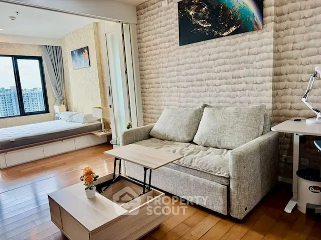 Modern studio apartment with cozy living area and bedroom, featuring stylish decor and natural light.