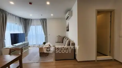 Modern living room with cozy sofa and large TV, perfect for relaxation.