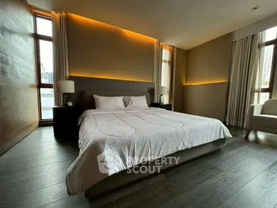 Luxurious bedroom with modern lighting and large windows in upscale apartment