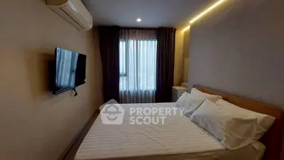 Cozy bedroom with modern amenities and natural light